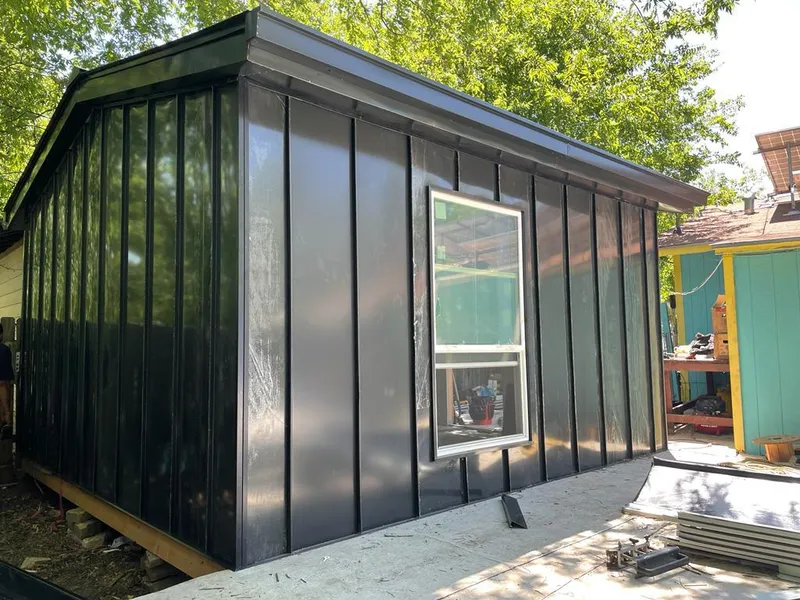 Black standing seam metal wall panels for Roof Inspection in McPherson